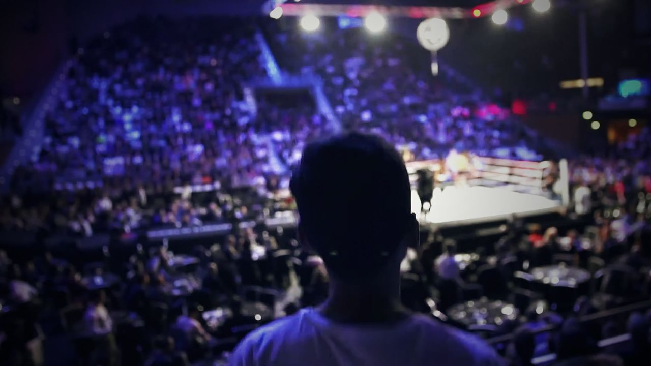 A young fan watches the lit-up ring from the stands